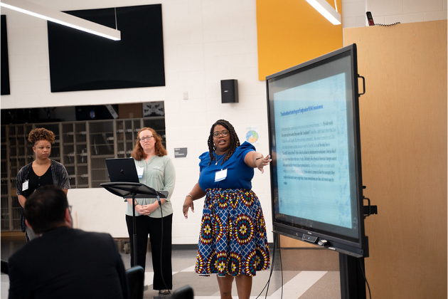 Teachers sharing their work and findings with the team